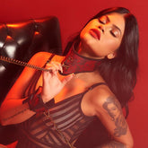 Black leather collar with silver studs and chains, perfect for a dominatrix look