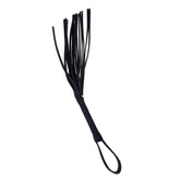 A leather Pleasure Whip with a black handle and tassels