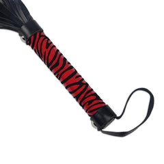 Red whip with long handle and intricate detailing to enhance play