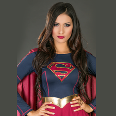 An image of the powerful and confident SUPERGIRL standing with her iconic cape flowing in the wind, representing strength and courage