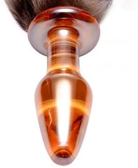 Person holding a PLUG COLA CRISTAL bottle with a vibrant and colorful label