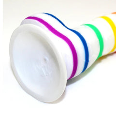 Hand holding the Pure Pride Dildo to show the size and girth of the product