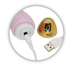 A woman holding a bead-shaped vibrator in her hand, showing its size and texture