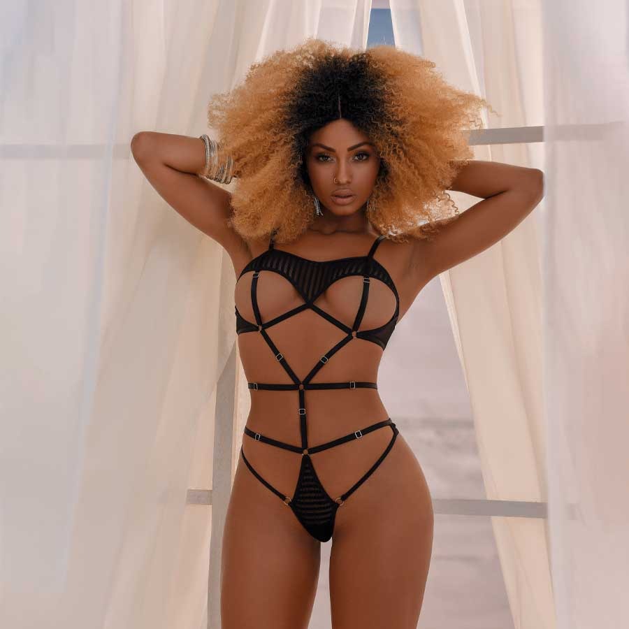 Close up image of Body Mimosa lotion being applied to skin, showing its rich, hydrating texture and luxurious packaging