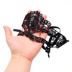 Close-up of woman wearing black satin sleep mask with delicate lace trim and elegant design