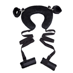 Ergonomically designed sex pillow in black with adjustable ankle restraints