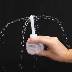 White minimalist handheld anal shower for personal hygiene in bathroom