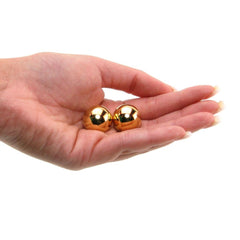Set of gold Ben-Wa balls for intimate play and strengthening pelvic muscles