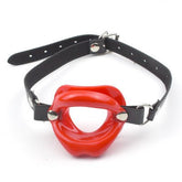Red ball gag with black leather strap and lips design on the ball