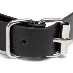 Woman wearing a ball gag with attached nipple clamps and chains