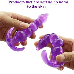 Hand holding metal butt plug with jeweled end for visual appeal and easy handling