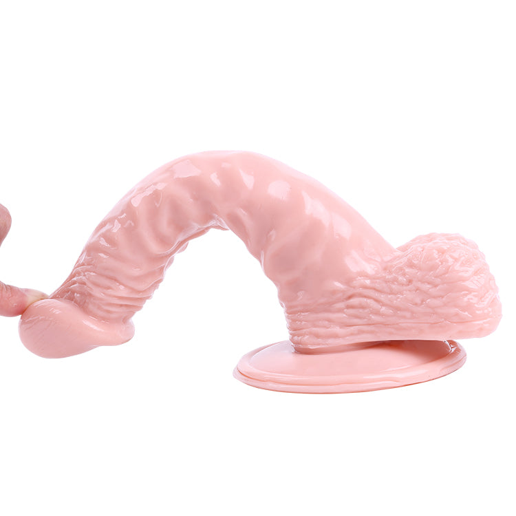 Woman's hand holding camel-colored realistic dildo with veins and glans