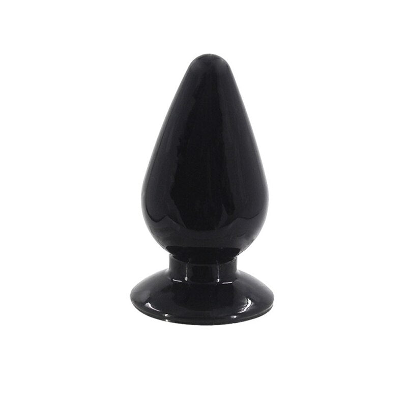 Close-up of hand holding anal plug with tapered tip and slim neck